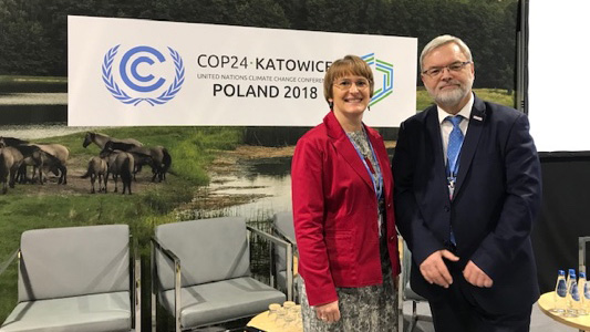 Sarah Lennon and Jozef Sobolewski at COP24 standing in front of COP 24 banner